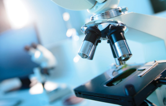 Microscopic view of surgical tool production, highlighting CNC-machined orthopedic implants with Ra 0.2μm surface finish for biocompatibility.