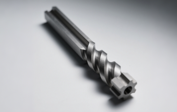 CNC-turned metal drill bit with precision spiral flutes, showcasing thread-cutting capabilities in turning operations. The helical grooves facilitate chip evacuation during drilling processes.